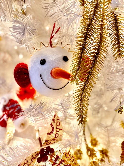 A Snowman Plush Toy Hanging on White Christmas Tree