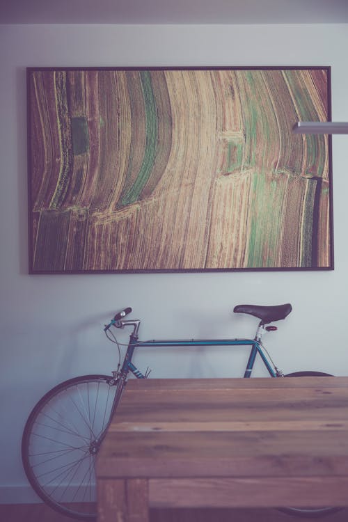 Black and Gray Bicycle on Brown Wooden Floor
