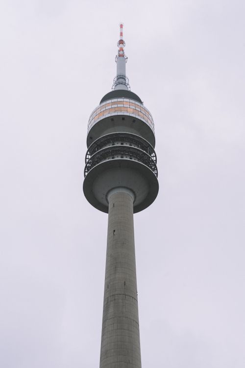 Free Vertical shot of the iconic Olympic Tower in Munich, showcasing its unique architectural design. Stock Photo