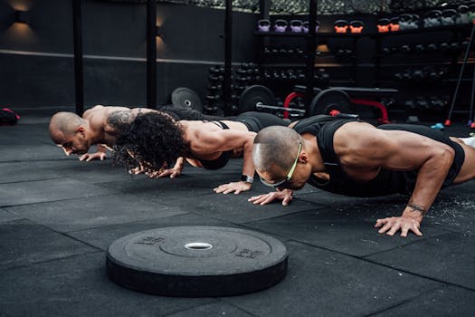 Group workout session in a Mexico City gym with athletes doing push-ups.