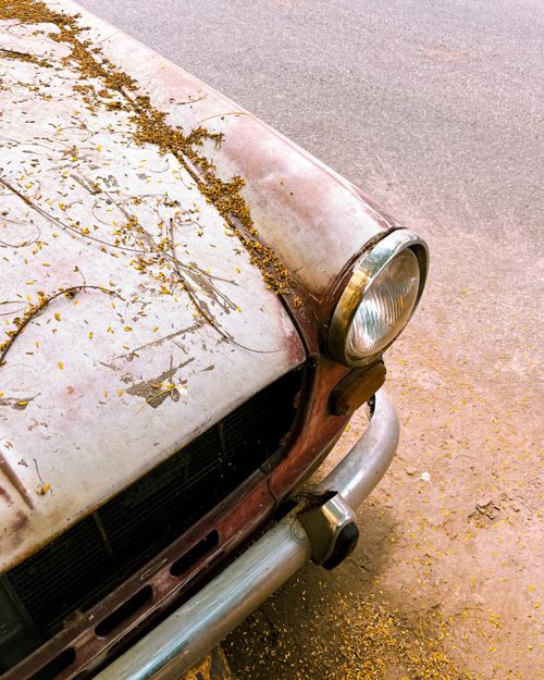 Free Rusty, vintage car with peeling paint viewed close-up on a deserted roadside. Stock Photo