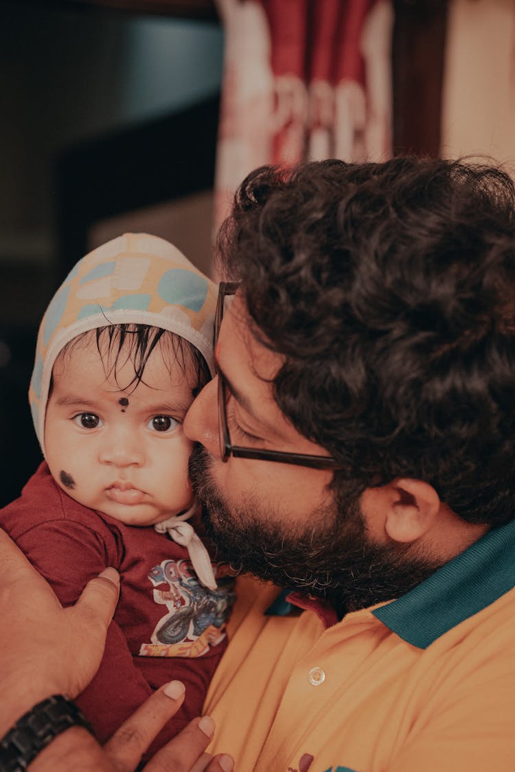 A Man Kissing A Baby