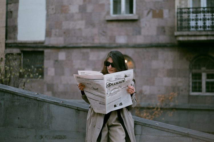 A Woman Reading A Newspaper