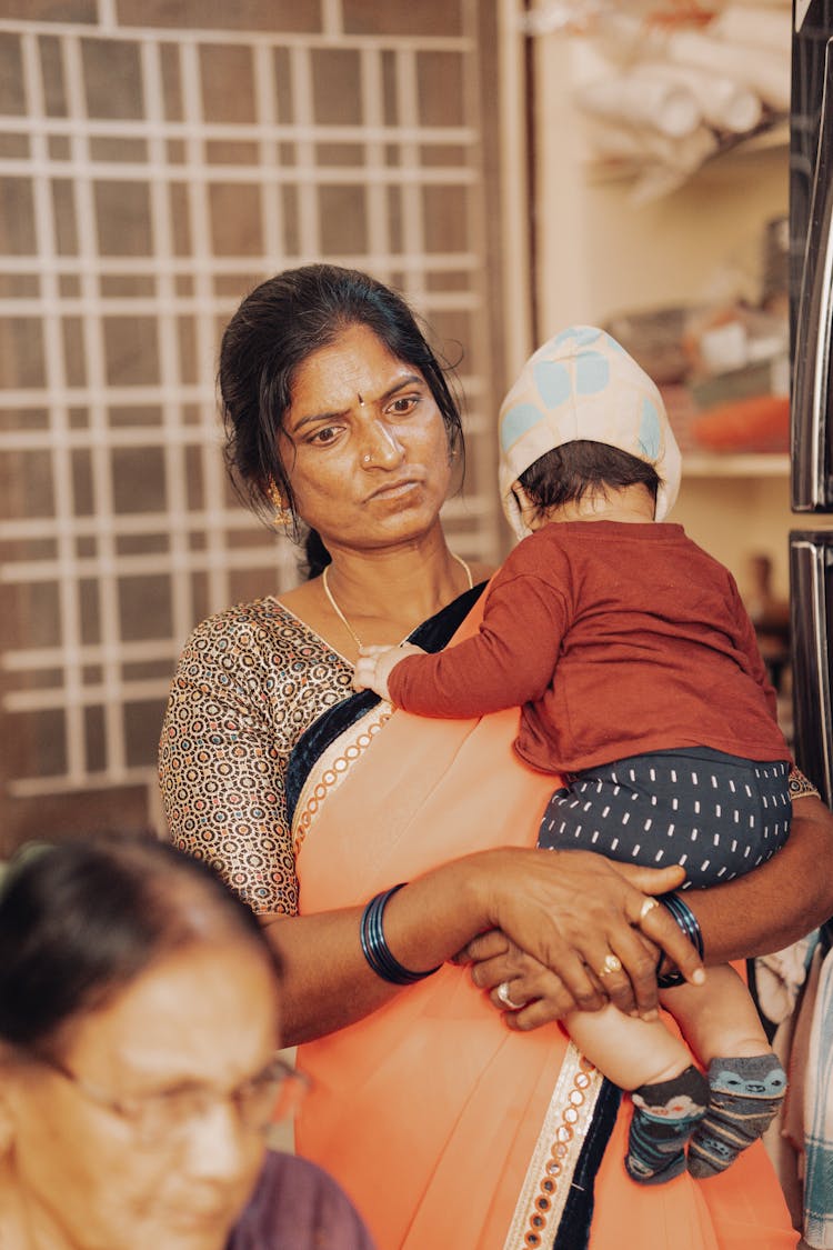 A Woman Holding A Child 