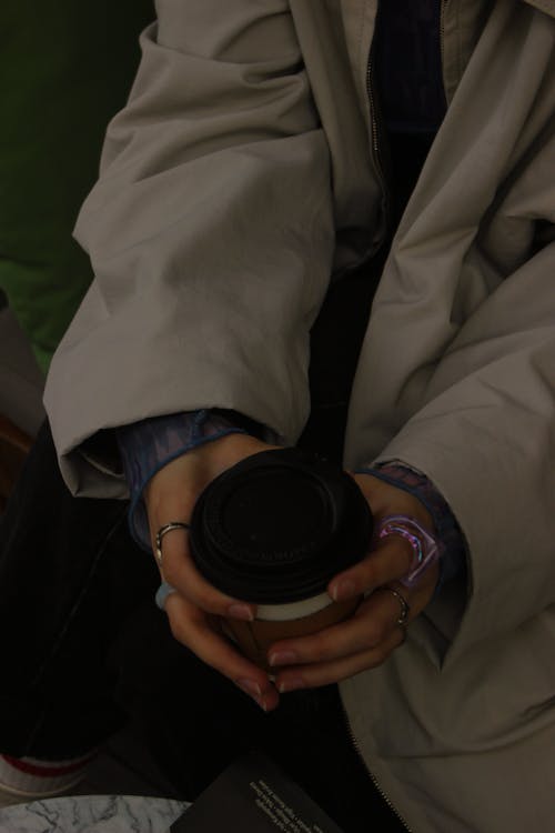 A Person Holding Black Disposable Cup