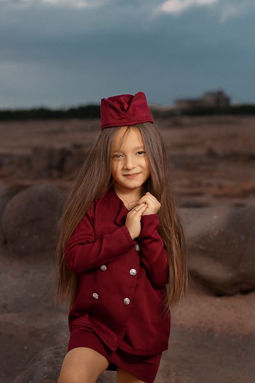 Free Charming child dressed as a flight attendant posing outdoors, showcasing kids' fashion. Stock Photo