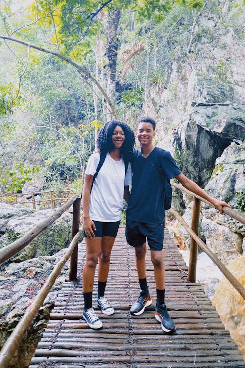 Young Man and Woman Standing on a Footbridge