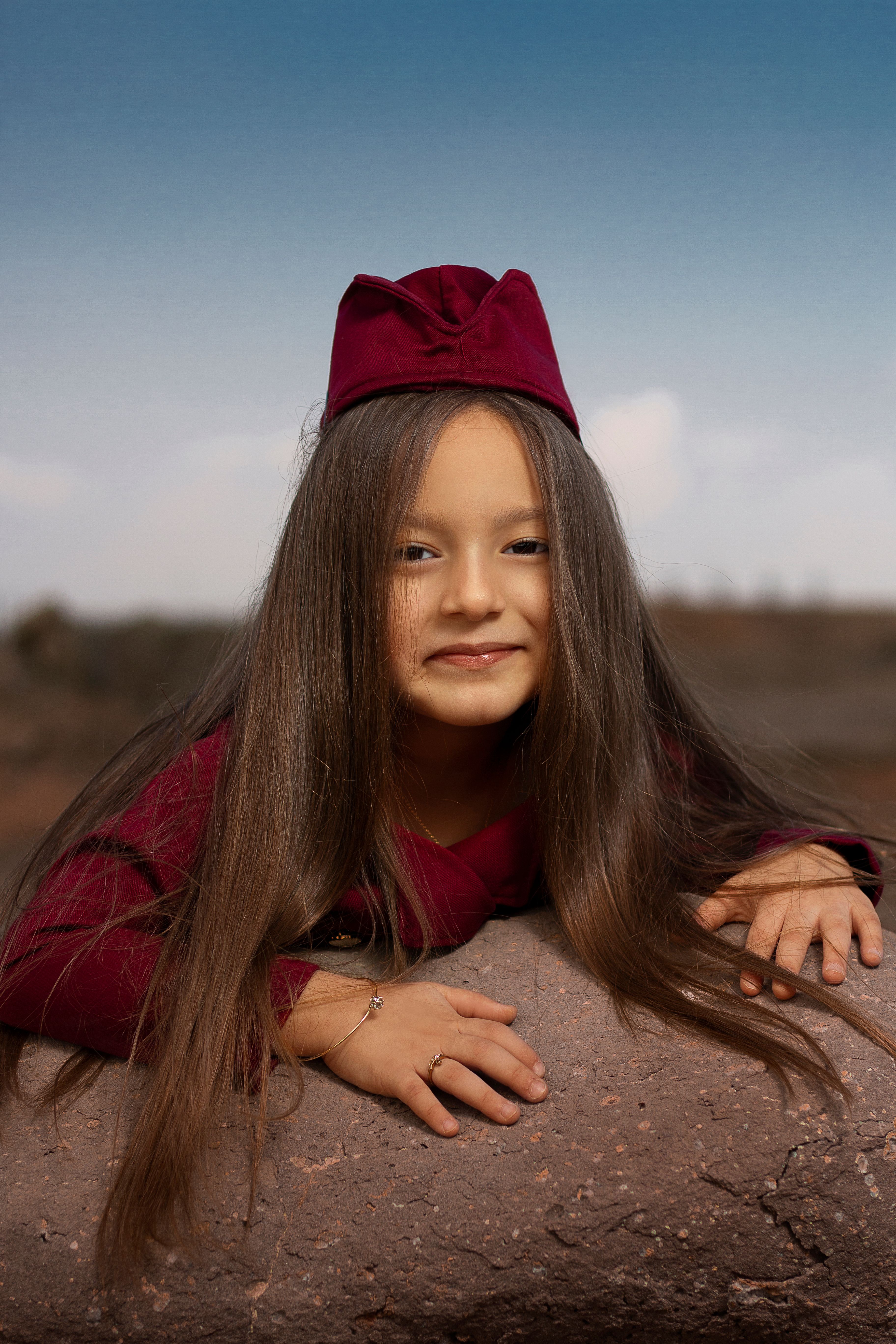 A young girl with long hair and a red hat · Free Stock Photo