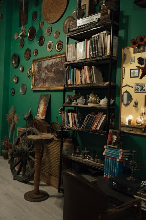 Free Cozy vintage room decorated with antique objects and bookshelves, evoking nostalgia. Stock Photo