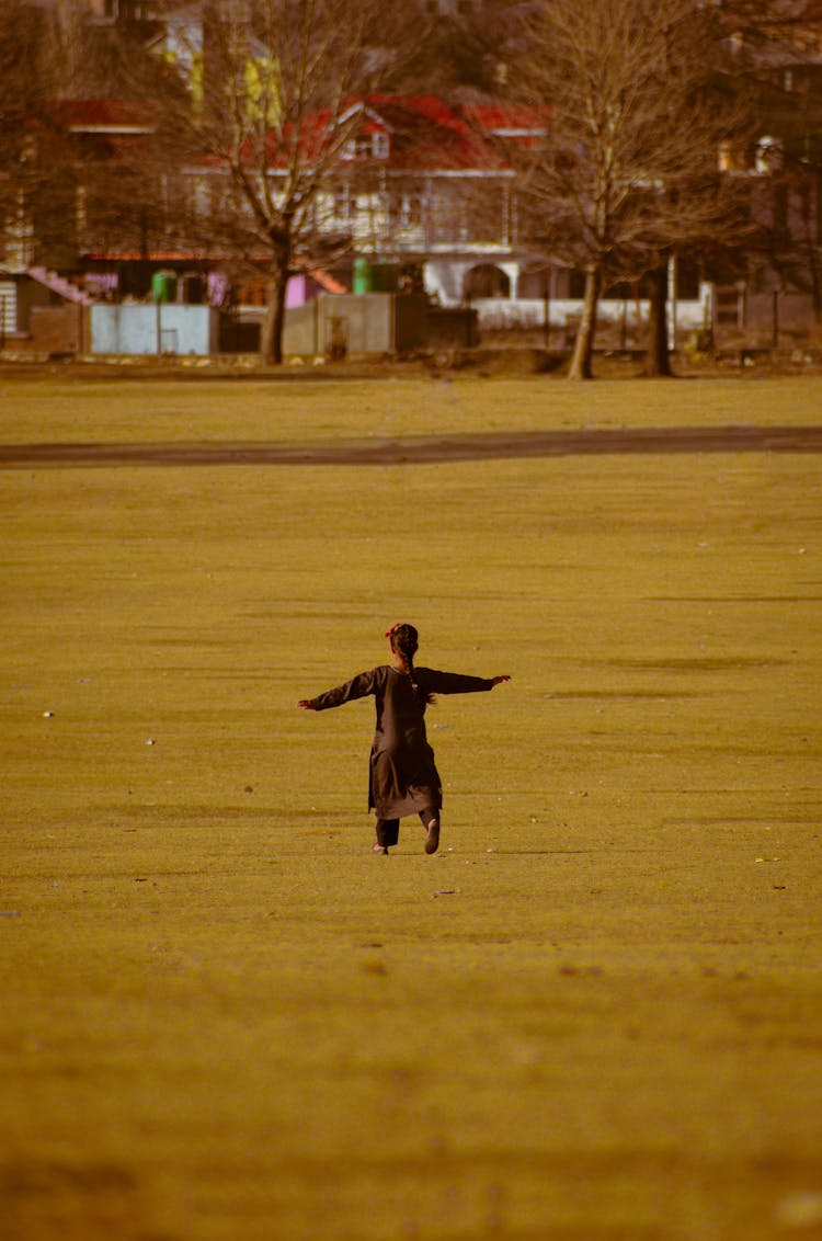 Girl Running On A Meadow