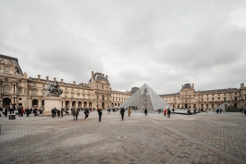 People Walking in Front of Louvre Museum