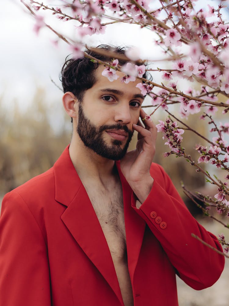 A Man In Red Suit Posing