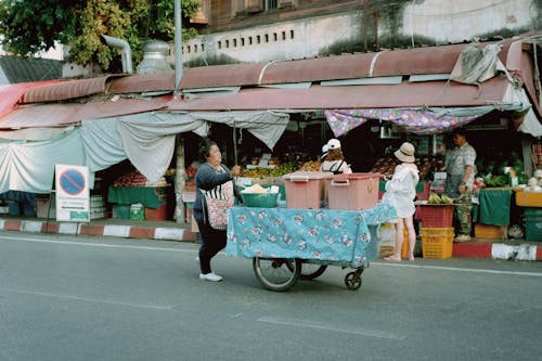 Woman Pushing a Market Cart
