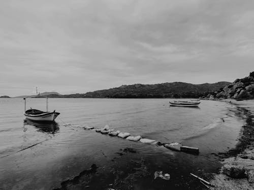 Grayscale Photo of Boat on Sea