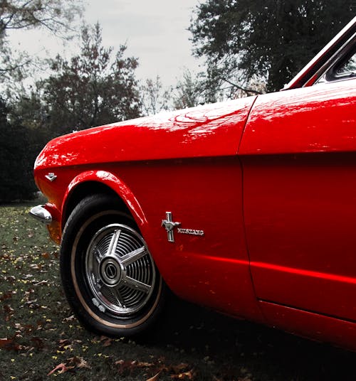 Close up of a red ford mustang on wild terrain