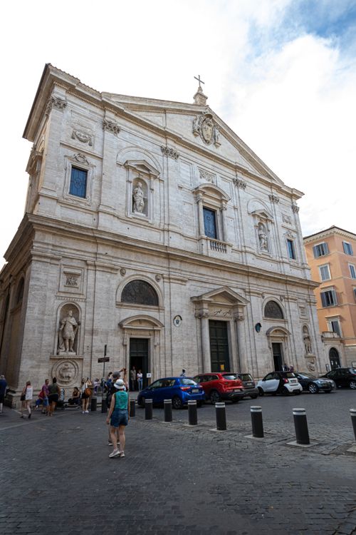 Free Low-angle view of a Baroque church facade in Rome, capturing architectural details and urban life. Stock Photo