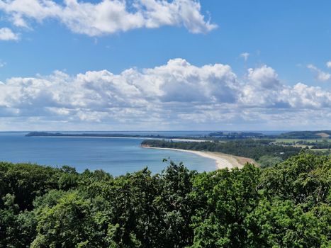 Breathtaking view of the coast in Göhren, Germany, under a vibrant blue sky.