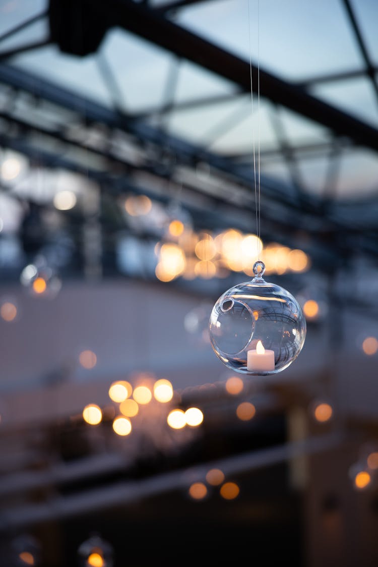 A Christmas Ornament With A Candle