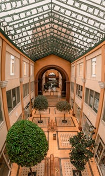 Beautiful indoor mall in Tunja, Colombia featuring elegant arches and lush greenery.