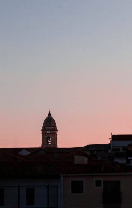 Silhouette of Tower on a Roof During Sunset 