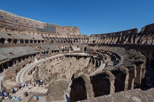 Free Explore the impressive architecture and historical significance of Rome's iconic Colosseum under a clear blue sky. Stock Photo