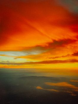 Breathtaking aerial capture of colorful sunset skies above clouds.