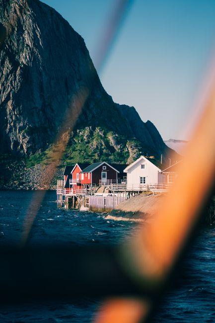 Beautiful waterfront houses in Reine, Nordland, Norway with a mountain backdrop.
