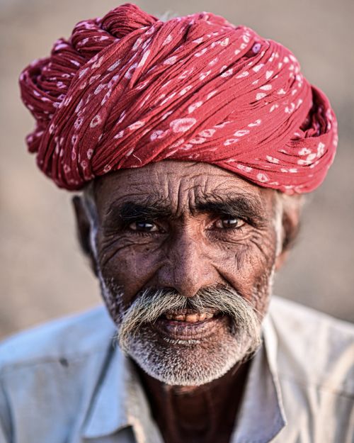 Free Close-up of an elderly man with a red turban, showcasing cultural attire and character. Stock Photo