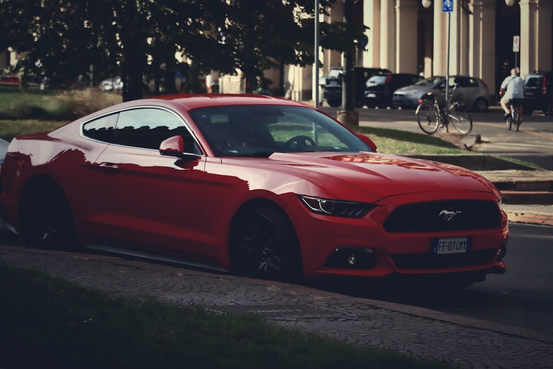 A Red Sports Car Parked on the Street · Free Stock Photo