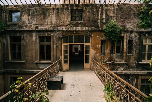 Free Explore the charm of an old, worn out building with intricate iron railings in this atmospheric photo. Stock Photo