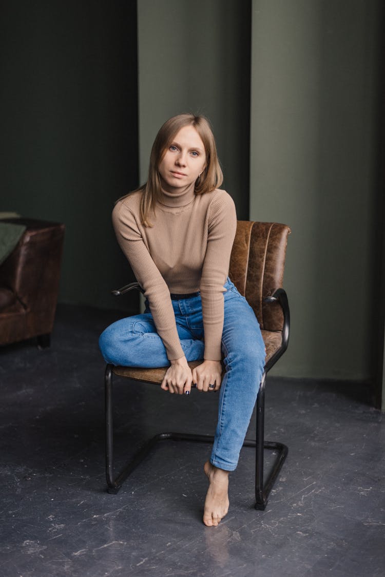 Barefoot Woman Sitting On Office Chair