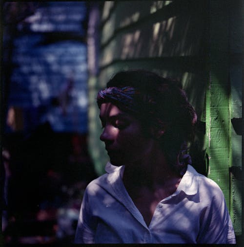 Woman Wearing Headscarf Among Tropical Leaves 