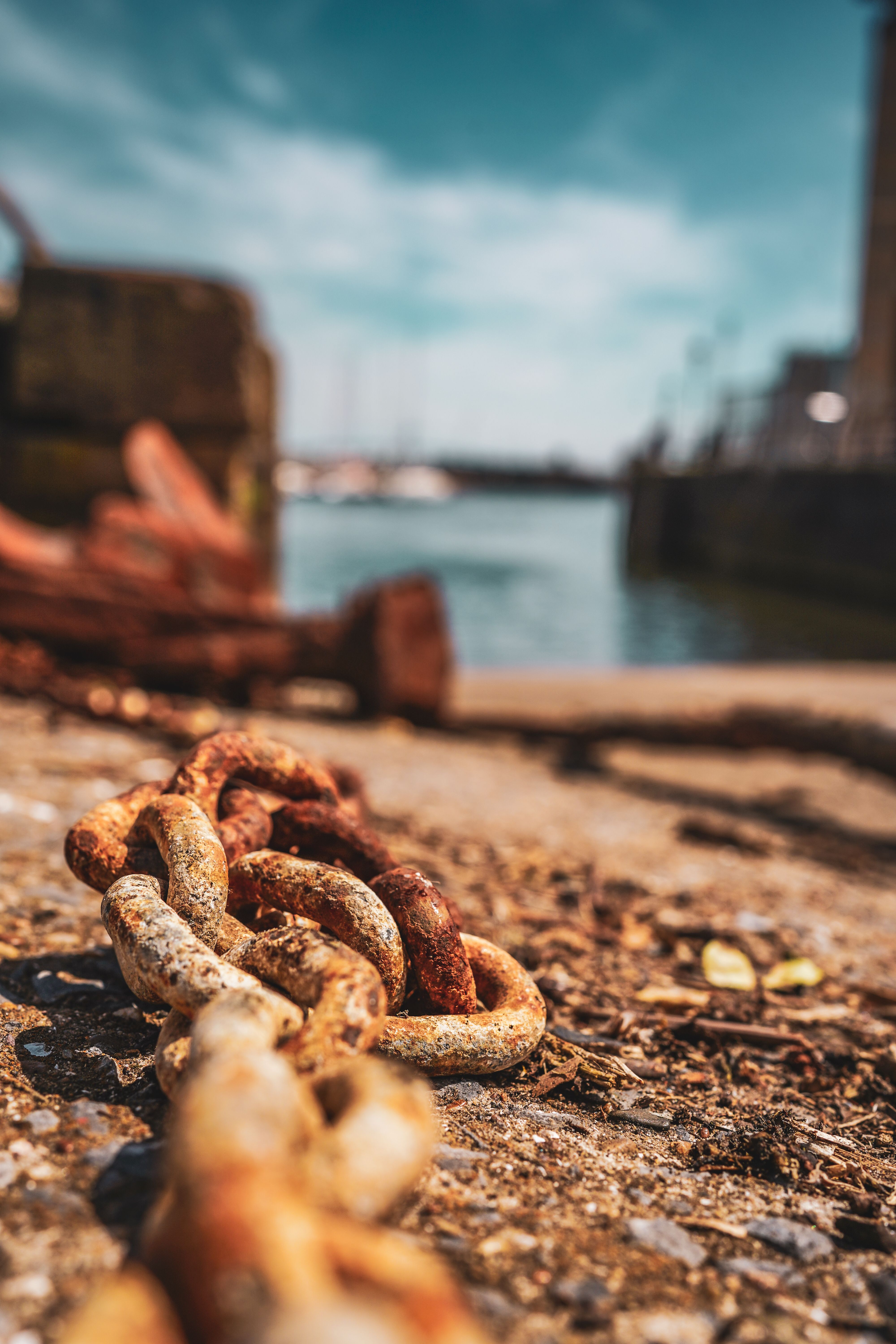 Close-up of a Rusty Chain Lying on the Beach in Port · Free Stock Photo
