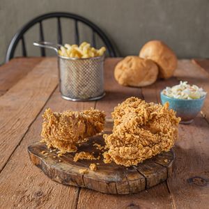 Fried chicken on a wooden board — photo by Mounir Salah on Pexels