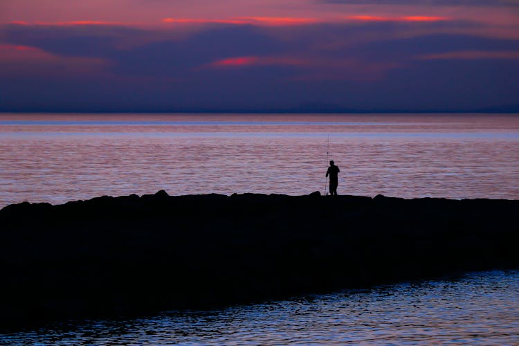 Man Fishing At Dawn