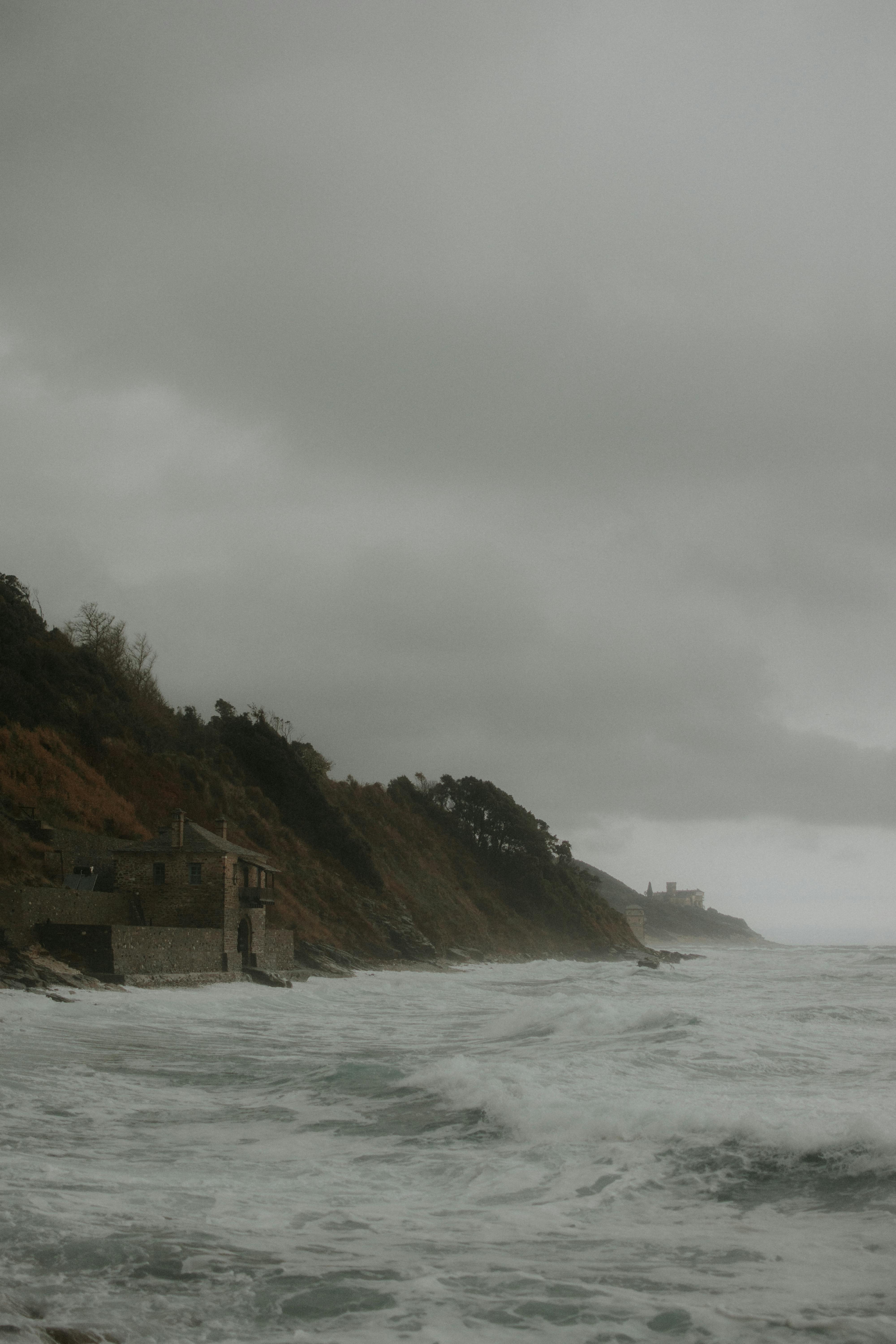 a house on the beach with waves crashing in