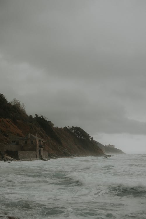 A house on the beach with waves crashing in