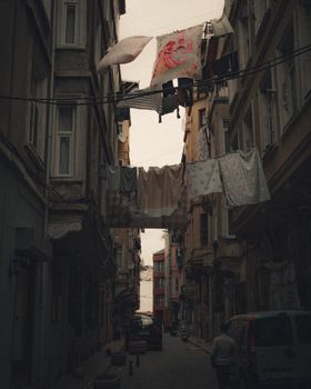 Narrow İstanbul street with hanging laundry creating a vintage atmosphere.