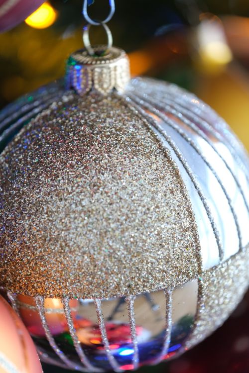 Free A sparkling Christmas ornament with glitter and reflective details, perfect for holiday decor. Stock Photo