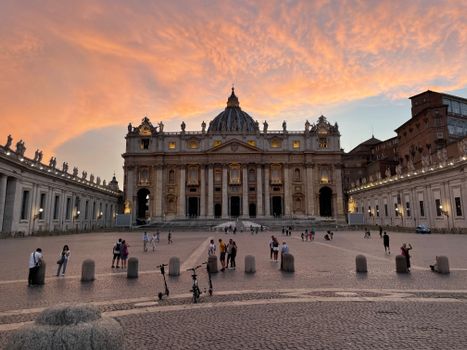 Stunning view of St. Peter's Basilica and Vatican City at sunset with vibrant skies.