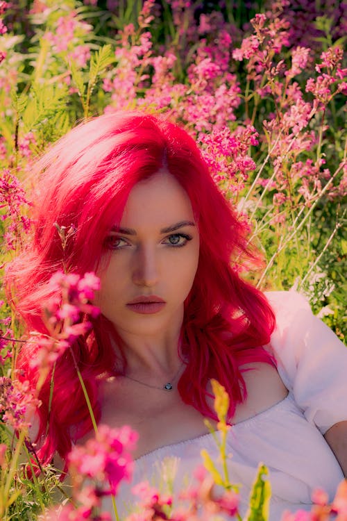 Woman with Pink Hair Posing in Summer Field