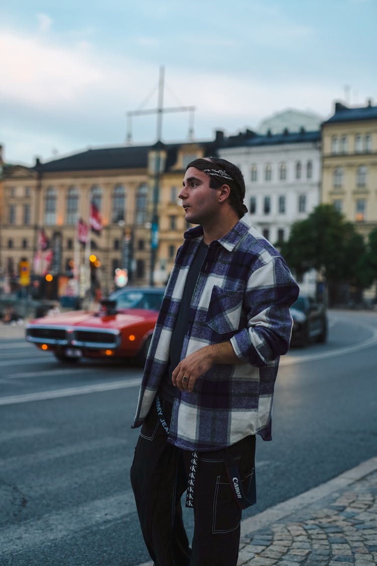 Man In A Flannel Shirt Standing By A Street