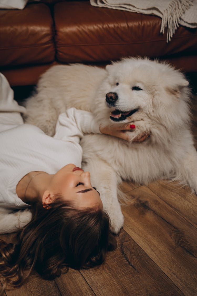 Woman Playing With Dog On Floor