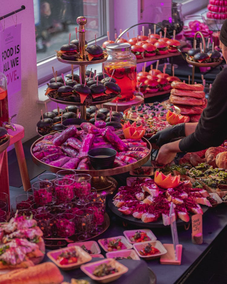 Person Arranging A Buffet Sandwich Table