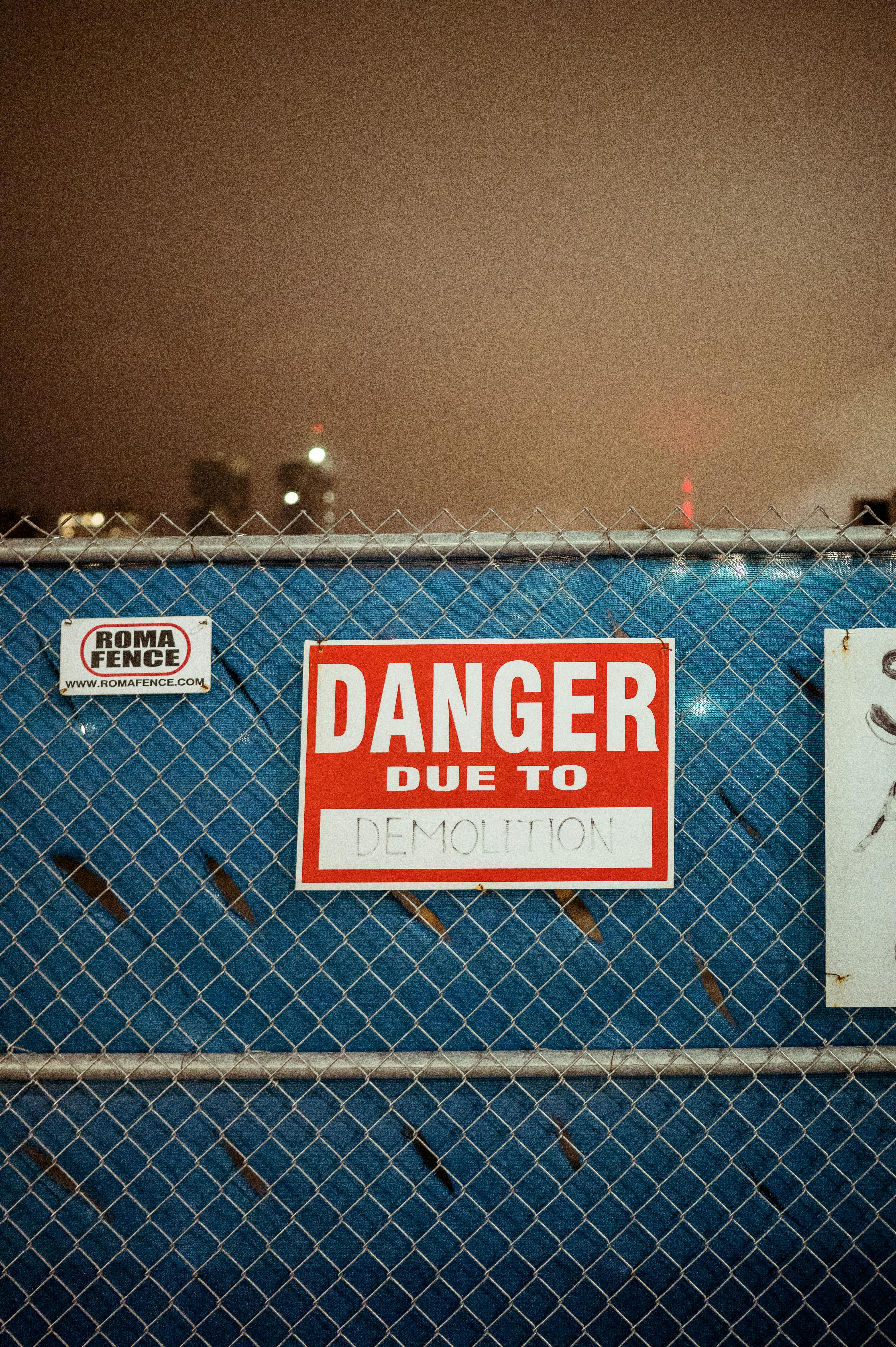 close up of the danger signage on the metal fence
