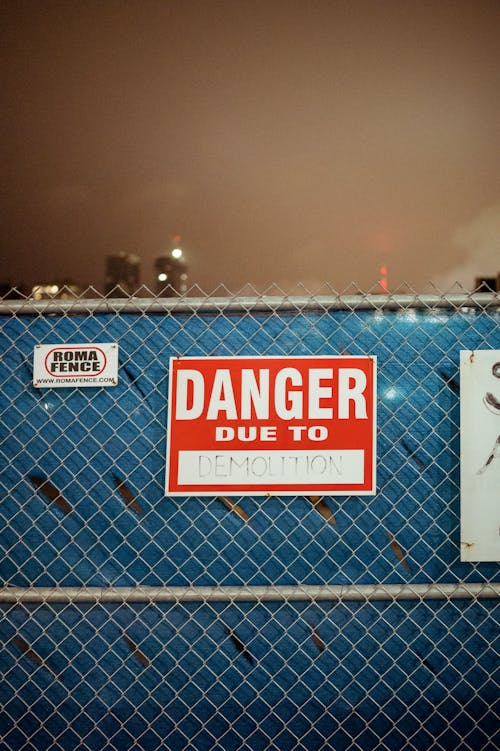 Close-up of the Danger Signage on the Metal Fence
