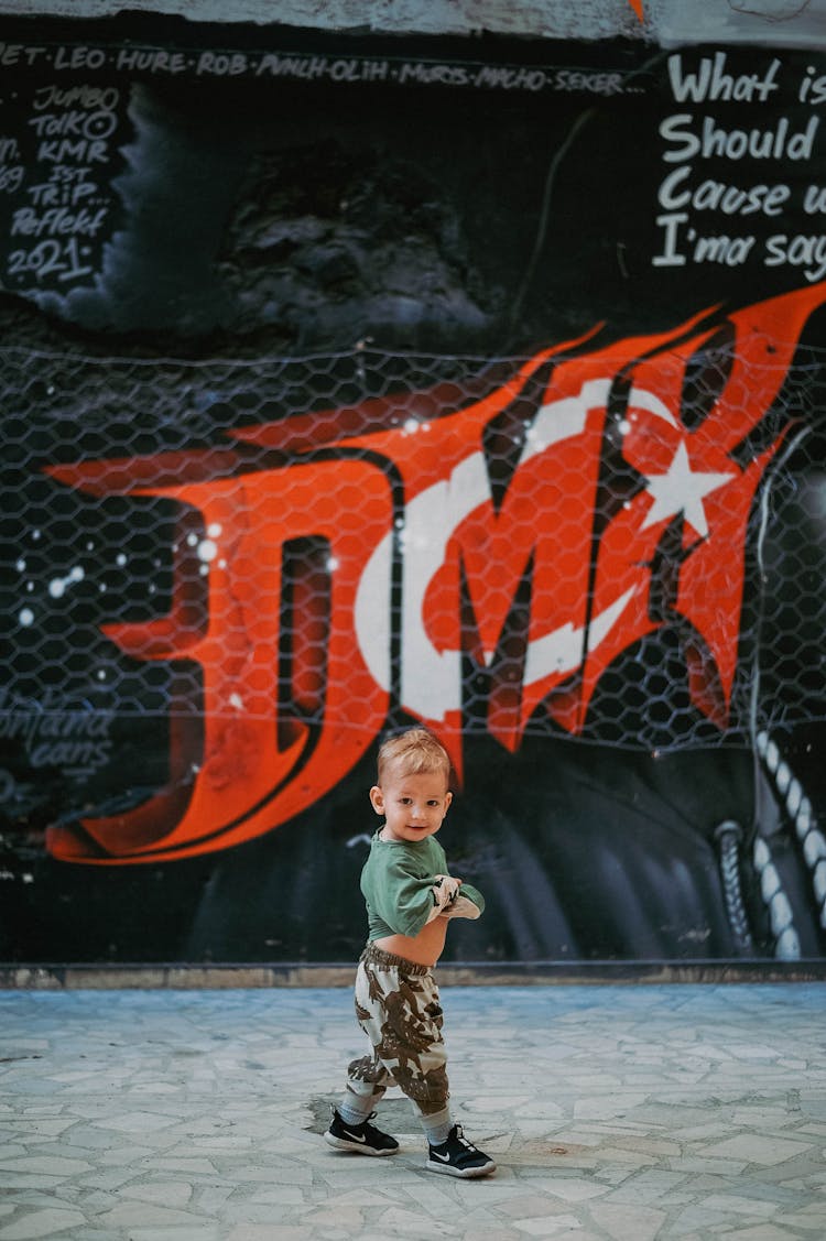 Photograph Of A Toddler In A Green Shirt