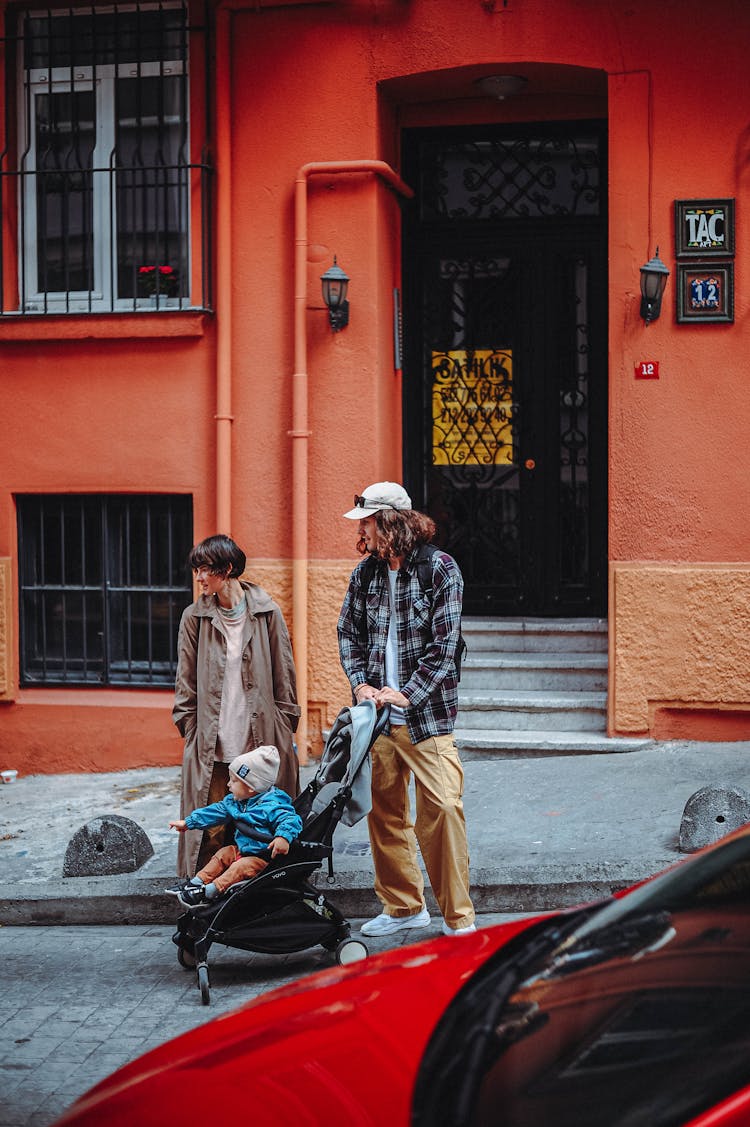 Mother And Father With Child In Stroller