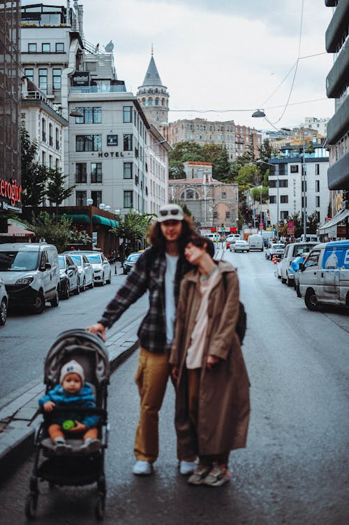 Couple Standing in the Street with a Baby in a Stroller