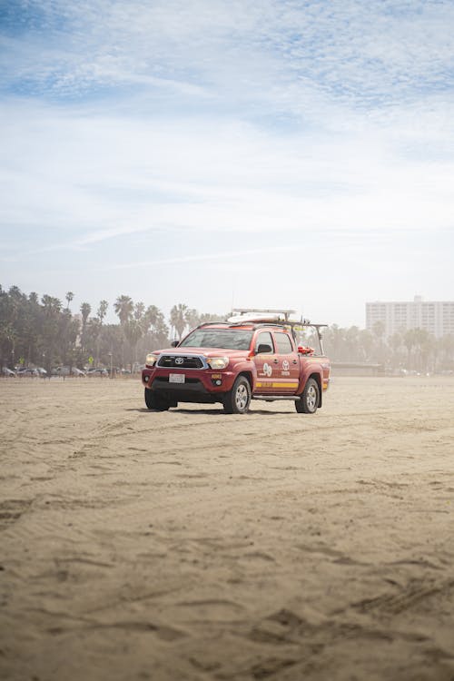 Red Pickup Truck on Brown Sand